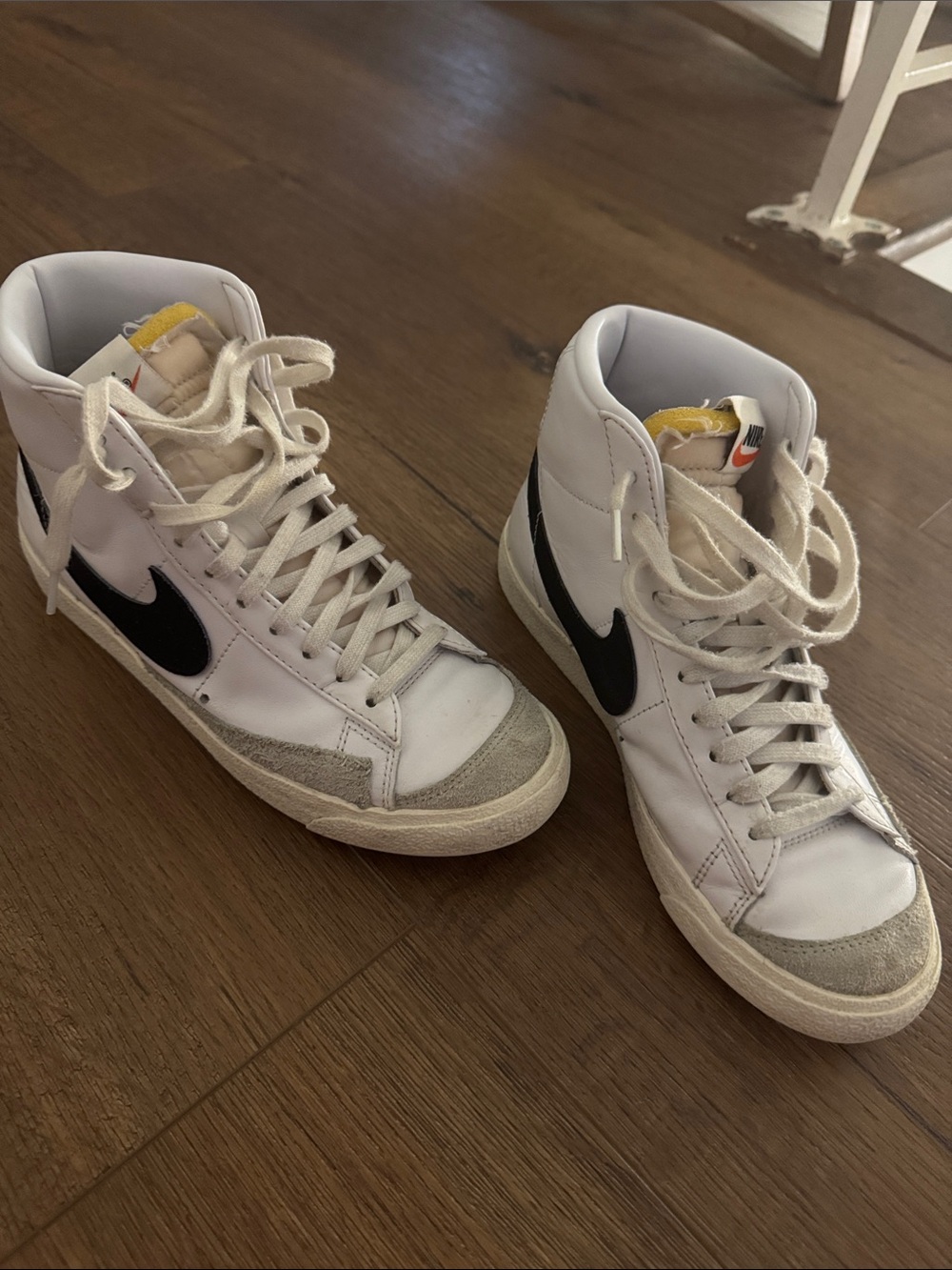 Nike White High-Top Sneakers with Black Swoosh and Tongue Tab